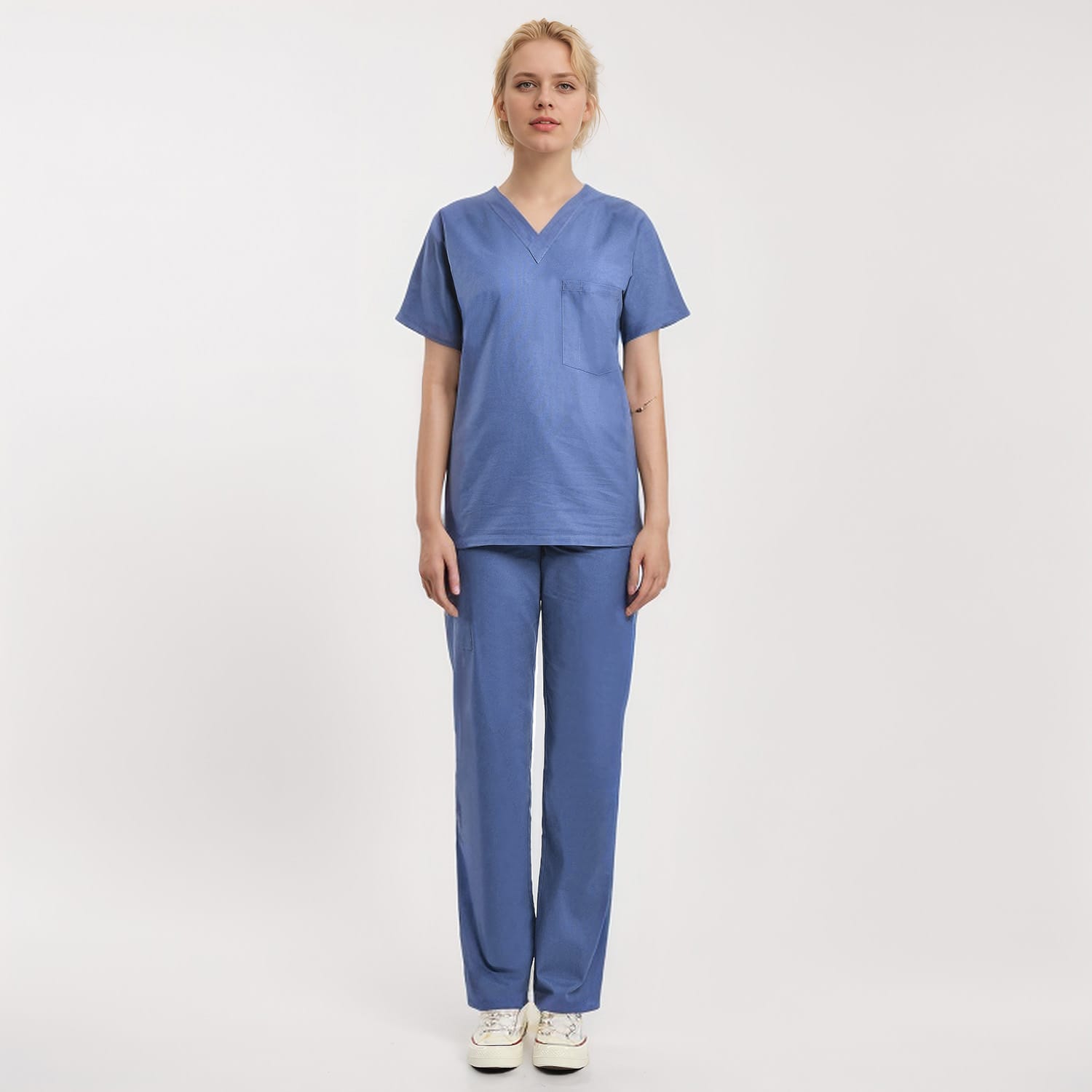 Front view of a model wearing a blue Scrub Unisex 1-Pocket V-Neck Scrub Top, perfect for healthcare workers.