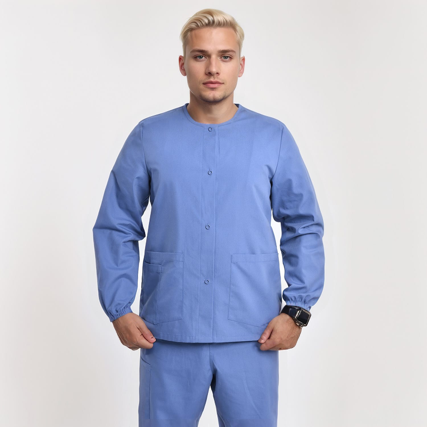 Front view of a model wearing a blue unisex 3-pocket warm-up scrub jacket with long sleeves, ideal for healthcare professionals.