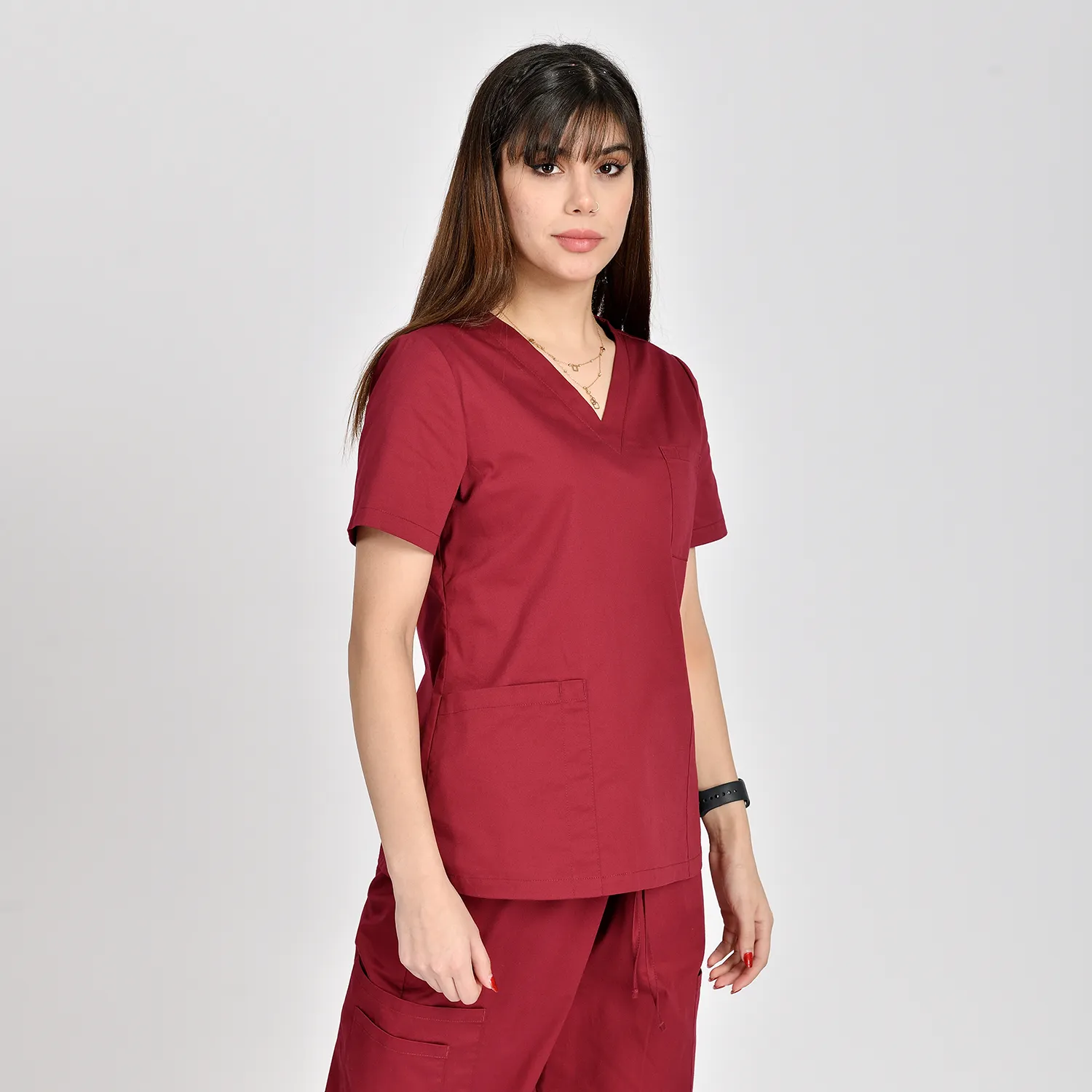Maroon women's V-neck medical scrub top featuring three pockets, short sleeves, and breathable fabric for comfort and durability in healthcare settings.